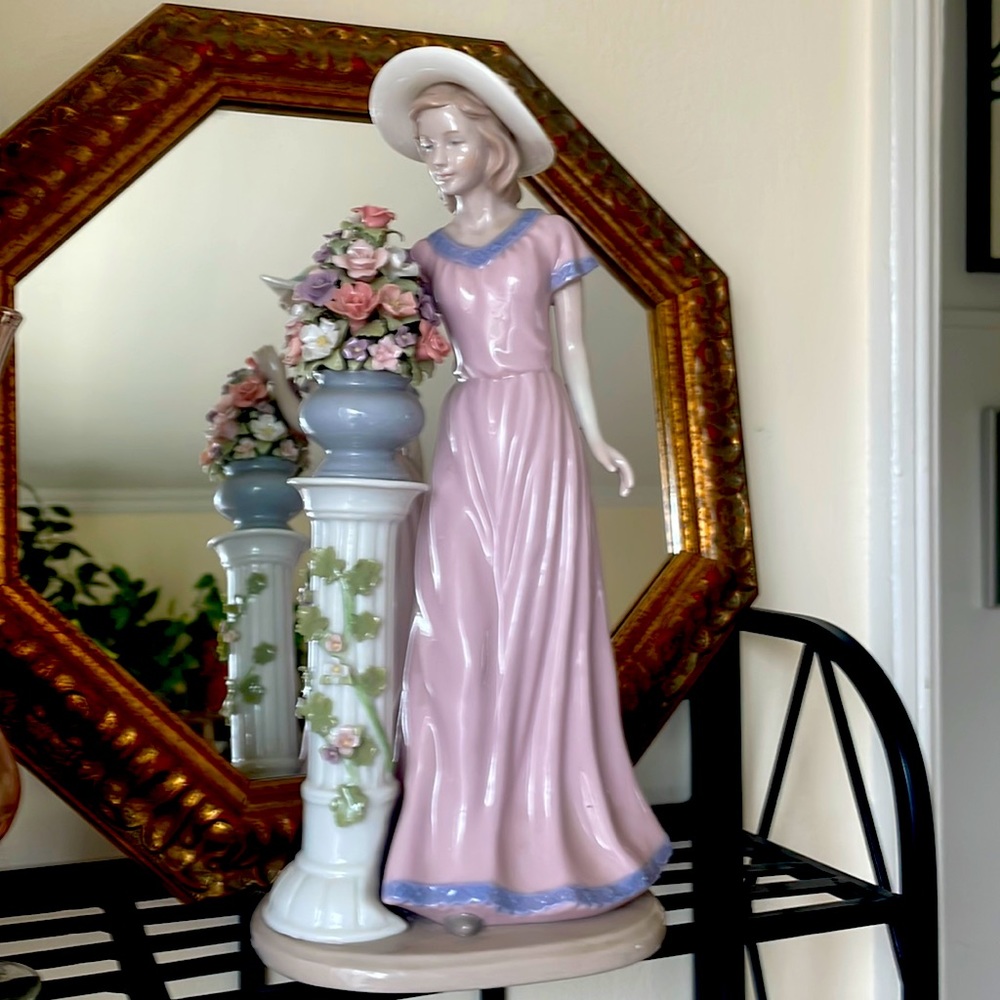 Porcelain figurine of a lady and gorgeous flower arrangement
